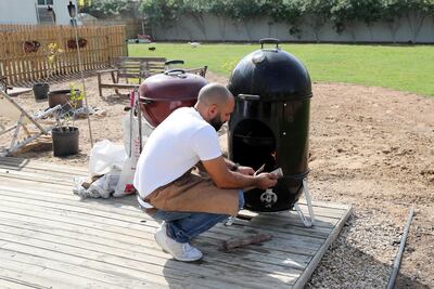 Hattem Mattar preparing the wooden grill at the Mattar Farm Kitchen. Pawan Singh / The National
