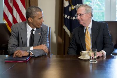Then US president Barack Obama, left, talks to then Senate minority leader Mitch McConnell in 2014. McConnell used the filibuster to obstruct Obama's plans. Bloomberg