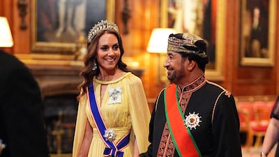 Catherine, Princess of Wales walks with Khalid Al Busaidi, Minister of the Diwan of the Royal Court of Oman, as they walk into the banquet. AFP