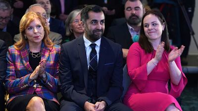 Fellow leadership candidates Ash Regan, left, and Kate Forbes, right, applaud Mr Yousaf after the announcement. PA