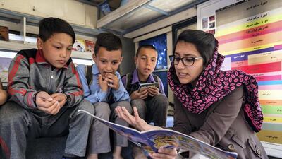 Freshta Karim reading to a group of boys on the bus. Kern Hendricks for The National