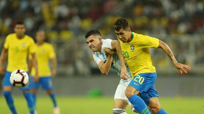 Roberto Firmino, right, fights for the ball with Argentina midfielder Rodrigo Battaglia during the match at the King Abdullah Sport City Stadium in Jeddah. AFP