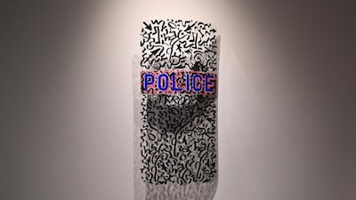 A police shield by artist LA2/LAROC (Angel Ortiz) is displayed during a press preview at Sotheby's Hip-Hop acution. AFP