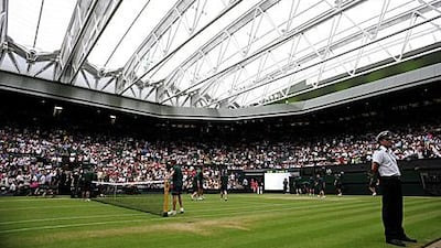 The roof is closed over Centre Court as rain stops play during the match between Amelie Mauresmo of France and Russia's Dinara Safina today.
