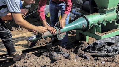 Gazan Entrepreneur Project Turns Olive Waste into a Valuable Resource. The team uses its machine to produce green cakes. Photo by Muhammad Shehada