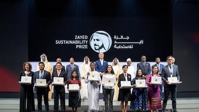 Sheikh Mohammed bin Rashid, Vice President and Ruler of Dubai, Sheikh Mohamed bin Zayed, Crown Prince of Abu Dhabi and Deputy Supreme Commander of the Armed Forces, and Dr Sultan Al Jaber, Minister of State, chairman of Masdar and chief executive of Adnoc Group, stand for a photograph with this year's winners of the Zayed Sustainability Award. Mohammed Al Hammadi / Ministry of Presidential Affairs