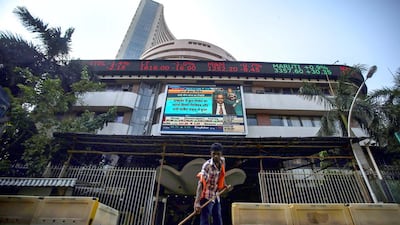 An Indian sweeper cleans the road outside the Bombay Stock Exchange building, in Mumbai. According to reports, the Bombay Stock Exchange sensitivity index (sensex) traded a new record-high of 28,114.03 Divyakant Solanki / EPA