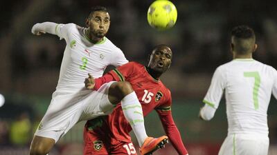 Algeria's Faouzi Ghoulam fights for the ball with Malawi's Robert Ngambi during their Africa Cup of Nations qualifying match on Wednesday in Blida. Louafi Larbi / Reuters