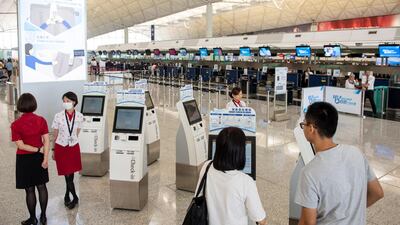 Passengers line up at check-in counters at Hong International Airport. EPA