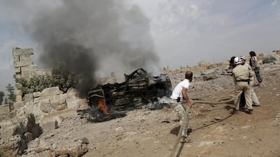 Firefighters put out flames at a base controlled by Ahrar Al Sham rebels. Activists say the blaze was the result of Russian airstrikes. Khalil Ashawi / Reuters