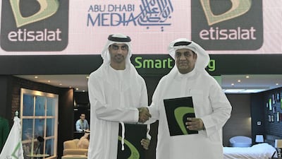 HE Mohamed Ebraheem Al Mahmood, the chairman of Abu Dhabi Media, left, and Saleh Al Abdooli, chief executive of Etisalat. Jeffrey E Biteng / The National