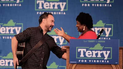 Musician Dave Matthews greets voting rights activist Stacey Abrams during a get-out-the-vote rally. Getty Images / AFP