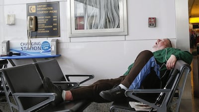 A man sleeps in a waiting area of the central terminal of LaGuardia Airport. Shannon Stapleton / Reuters