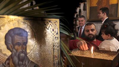 Palestinian Orthodox attend the Palm Sunday mass in Gaza City on Sunday. AFP