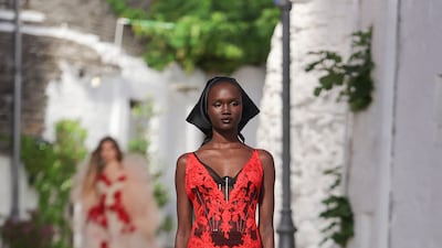 The pared-back show, which was held in the Italian town of Alberobello, also sent out models wearing traditional Italian headscarves