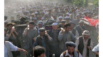 Afghan protesters carry the dead bodies of people who were killed by Nato-led forces in a night-time raid, in Taloqan, the capital of the usually peaceful northeastern province of Takhar, yesterday.