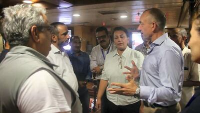 Lt Gen Michael Lollesgaard, right, talks to officials aboard a UN boat on which the Yemeni government and rebels were due to meet on Sunday, July 14, 2019. Ali Mahmood