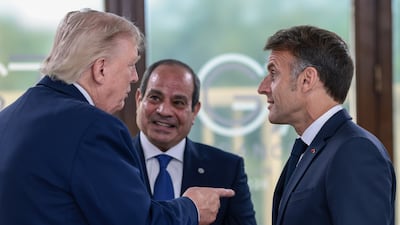 Mr Trump with Mr El Sisi and Mr Macron. Getty Images