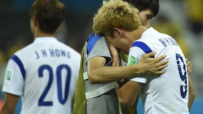 South Korea midfielder Son Heung-min, right, cannot hold back his tears following his team’s 1-0 loss to Belgium on Thursday. Odd Andersen / AFP