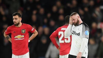 A dejected Wayne Rooney, right, after Manchester United scored their second goal in the FA Cup fifth-round tie against Derby County at Pride Park. Gettty