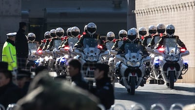 Police officers on motorcycles accompany a motorcade believed to be carrying Kim Jong Un, as they leave the railway station in Beijing. EPA