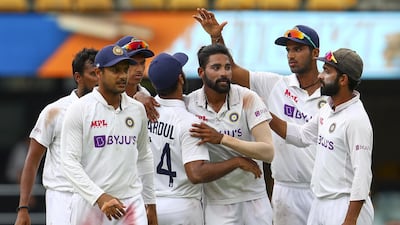 India's Mohammed Siraj, centre, is congratulated by teammates after taking his fifth wicket against Australia on Day 4 of the fourth Test at the Gabba on Monday, January 18. AP