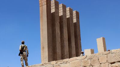 A soldier stands next to the 3,000-year-old Temple of the Moon in Marib, Yemen. The soon-to-be-returned antiquities were looted in 1994 during Yemen's civil war. Reuters