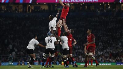 England flanker Tom Wood, centre, wins the ball in a line-out during the opening match of the 2015 Rugby World Cup. Adrian Dennis / AFP