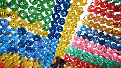 A Bhuddist temple worker attaches a name card with a wish to a lantern during a ceremony of Buddha's birthday at Jogyesa Temple in Seoul, South Korea. Getty Images