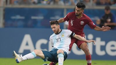 Argentina's Lionel Messi is fouled by a Qatar player. EPA
