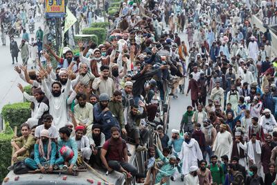 Supporters of Tehrik-e-Labaik Pakistan stand atop a vehicle while others walk during a protest demanding the release of their leader and the expulsion of the French ambassador over cartoons depicting the Prophet Mohammed, in Lahore, in October. Reuters