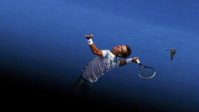 A bird flies past Tomas Berdych as he serves to Rafael Nadal during their Australian Open quarter-final match on Tuesday in Melbourne. Carlos Barria / Reuters