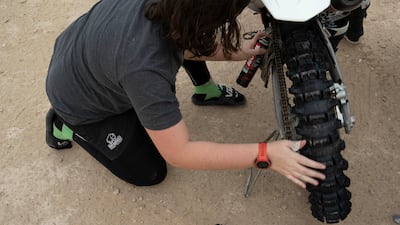Elisha Dessurne lubricating the chain in preparation for a ride