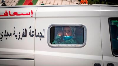 A Covid-19 patient arrives in a car park in the town of Moulay Bousselham, north of the capital Rabat, before being transferred to a medical centre in another city. AFP