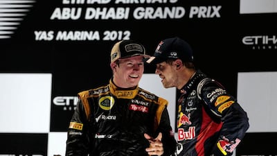 Kimi Raikkonen, left, of Finland speaks to Red Bull driver Sebastian Vettel, who came third, on the podium. Christopher Pike / The National