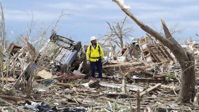 Rescuers search building-to-building for victims a day after a massive tornado tears through Moore, Oklahoma.