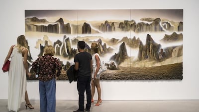 A piece by British artist Gordon Cheung, who uses newspaper cuttings as the base and paints over them. Antonie Robertson / The National