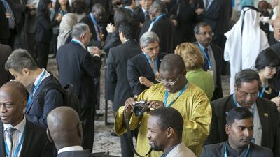 Delegates network during a break at fifth session of the International Renewable Energy Agency assembly. Silvia Razgova / The National