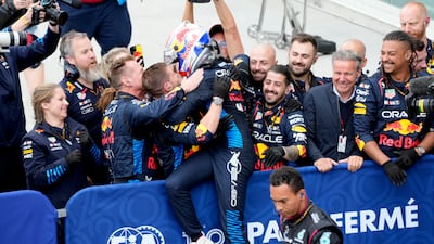 Verstappen celebrates with his team. AP