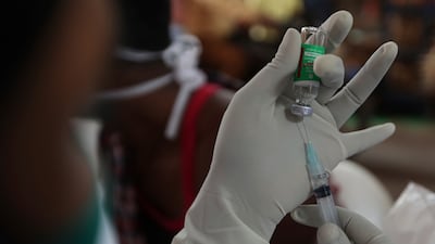 A health worker prepares a Covishield vaccine shot at a temple complex in Hyderabad, India. AP