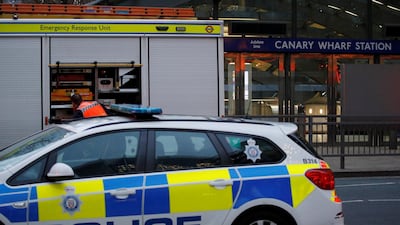 Emergency services outside of Canary Wharf tube station in London on Monday after a man fell from an escalator and died. Reuters