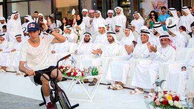 Triple world champion stunt cyclist Jorge 'Viki' Gomez entertains Saud bin Saqr Al Qasimi, Ruler of Ras Al Khaimah at the opening of Grove Village Mall. Ruel Pableo for The National