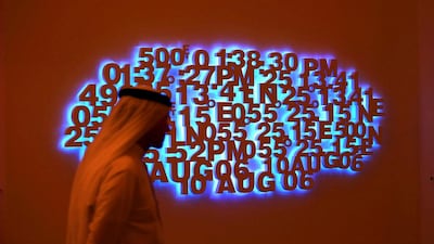 A visitor walks by the artwork Triangle from the Directions series at Art Dubai by the Emirati artist Mohammed Kazem. Ali Haider / EPA