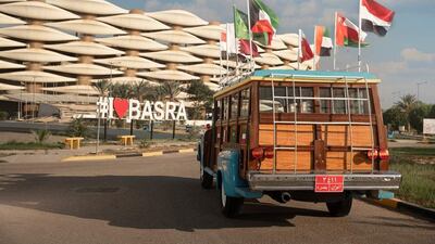 The Gulf Bus outside Basra International Stadium as the flags of the eight competing countries are displayed