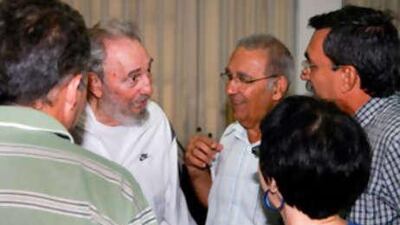 Former Cuban leader Fidel Castro meets workers of the National Centre for Scientific Investigation (CNIC) in Havana on July 7, 2010.
