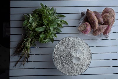 Sweet potatoes, maize-meal flour and a herb known as Murenda (jute mallow), used to prepare the national staple, Ugali (consumed for generations by the Luhya-speaking community), in Kenya, Nairobi, on December 16, 2021. AFP