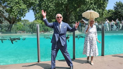 Britain's King Charles III (L) acknowledges the cheers from a the crowd at the penguin beach at ZSL London Zoo as he and Britain's Queen Camilla (R) visit to celebrate the zoo's 200th anniversary in central London on July 9, 2026. AFP