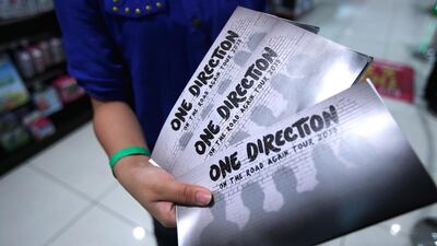 A fan holds up tickets she bought for the One Direction Dubai Concert, which will take place on April 4, 2015, on May 22, 2014 in Dubai, United Arab Emirates. Francois Nel / Getty Images
