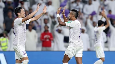Al Ain's Caio, right, and Tsukasa Shiotani celebrate Al Ain's success.