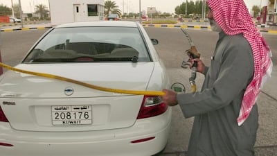 A man refills his car with petrol in Kuwait City, back in 2003. Eric Feferberg/AFP Photo